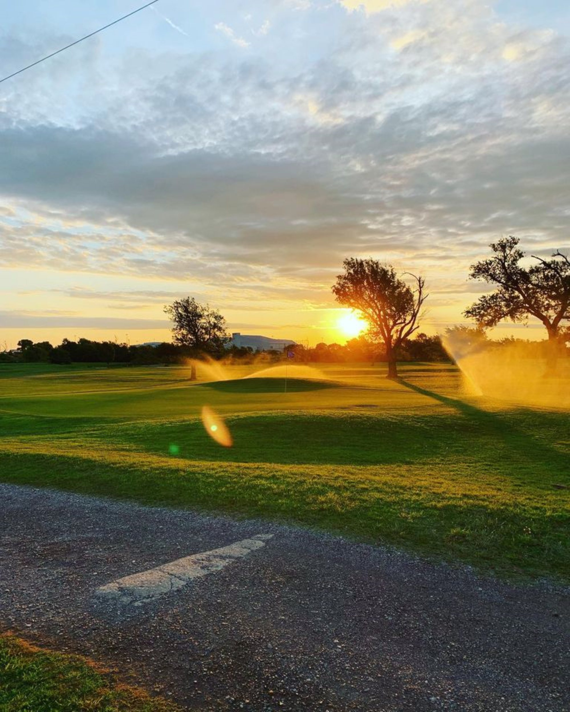 view of golf course at sunrise